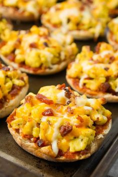 mini pizzas with cheese and bacon on them are ready to be baked in the oven