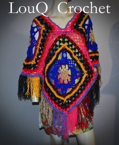 a crocheted shawl with fringes and beads on the shoulders is displayed in front of a mannequin's head