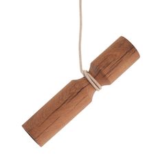 a wooden object hanging from a rope on a white background