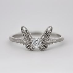 An upgraded version of the popular Fairy Companion Ring, which was inspired by Navi, Link's fairy companion in the Legend of Zelda: Ocarina of Time. This version has larger and more detailed wings, which resemble fairies in the more recent Zelda games. CUSTOMIZE GEMSTONES ✶ solid 14 karat recycled yellow, white, or rose gold✶ band measures 1.6mm wide x 1.4mm thick✶ natural diamond option: 0.10 carat VS clarity, G-I color natural conflict-free diamond✶ lab-grown diamond option: 0.10 carat VS clar Video Game Jewelry, Game Jewelry, Zelda Ocarina Of Time, Fairy Ring, Color Lab, Ocarina Of Time, Rose Gold Band, Recycled Gold, The Fairy