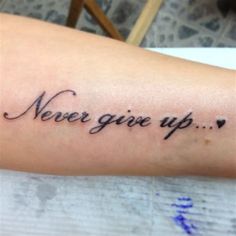 a tattoo saying never give up on the arm