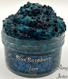 blue raspberry jam in a glass jar with the label on it that says, slimy jester