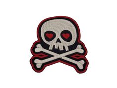 a skull and crossbone patch with hearts on it