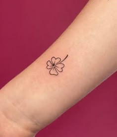 a small four leaf clover tattoo on the arm