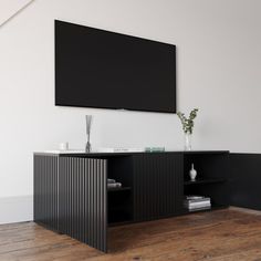 an entertainment center with a flat screen tv mounted on the wall and wooden flooring