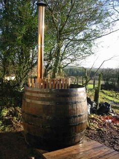 a wooden barrel sitting on top of a wooden platform