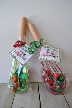 two plastic bags filled with candy on top of a wooden table next to a rolling pin