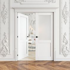 an empty room with white walls and wood flooring in the foreground, there is a door leading to another room