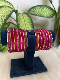 The perfect accessory for your special occasions, these  Hot pink and golden Color Bangles feature Pearl and Stone detailing. Crafted with copper, these bangles are sure to add a touch of elegance and glamour to your look. Features: * Copper material *  Stone detailing *   Hot pink and golden Color * Size: 2.6,2.8,2.10 Elegant Pink Bangle For Festivals, Handmade Pink Bangle For Festive Occasions, Traditional Pink Bangle For Party, Festive Handmade Pink Bangle, Pink Festive Party Bangle, Festive Pink Party Bangle, Pink Bangle For Festivals, Pink Bangle Bracelets For Festivals, Pink Handmade Traditional Bangle