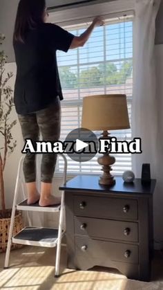 a woman is standing on a ladder in front of a window with the words amazon find