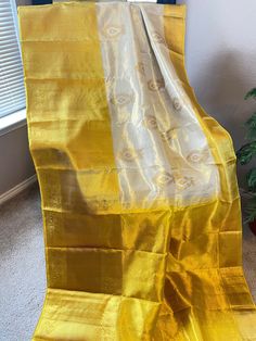 A very pretty beige and yellow combination in pure kanjeevaram tissue silk saree. With beautiful meenakari butta all over the body and a ganga jamuna border ( big lower border and small upper border). Comes with a golden yellow border and a rich pallu. Tassels done on both ends of the saree. Includes unstitched blouse piece. Lower border :12 inches Upper border : 4 inches Blouse measurements : 1.2 * 0.78 m Maintenance: Dry wash advisable Returns and refund only accepted on defective products. Product should be shipped back in 3 days after delivery . Please go through our return policies below. Our Policy on Returns, refunds and exchanges: We don't accept requests for returns and exchanges on the below observations: non-defects: Small knots or bumps in the silk threads. Uneven threads becau Yellow Handloom Tissue Silk Dupatta, Yellow Tissue Silk Dupatta, Yellow Tissue Silk Saree, Yellow Semi-stitched Tissue Silk Dupatta, Yellow Semi-stitched Tissue Silk Saree, Blouse Measurement, Silk Thread, Blouse Piece, Silk Sarees