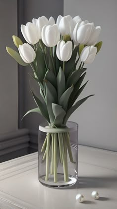 a vase filled with white flowers on top of a table