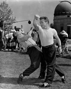 two men are playing baseball on the grass