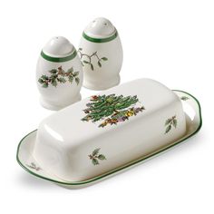 a set of christmas themed dishes with holly decorations