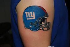 a new york giants helmet tattoo on the arm