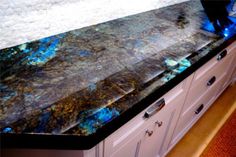 a counter top with blue and black marble on it