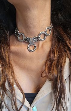 ◾ A beautiful and striking choker necklace made of silver-plated brass.    The necklace is adorned with round, twisted hoops, a foxtail chain, and a curb chain, making it suitable     For both evening and morning events. ◾   SIZE Length: 11.8IN (30cm) up to 16.5IN (42cm)       Width Hoop:  0.98IN(2.5cm).      Width curb: 0.39IN (1cm) thick chain: 0.19IN (5mm)      In addition to the length of the chain, there is an extension chain of 2.36IN (6cm) ◾   You can see a similar choker at this link:  ◾  NEW!  oxidized Chain bold necklace, Large circle Hoop necklace, Statement Chunky Necklace, large      Unique Choker collar, Edgy O ring Choker ◾  The shipment is in the registered mail including a tracking number.  ◾  This piece of jewelry is perfect as a gift for yourself, for a wedding day, Vale Thick Choker, Edgy Rings, Unique Choker, Ring Collar, Chunky Silver Necklace, Hoop Necklace, O Ring Choker, Choker Silver, Chain Collar