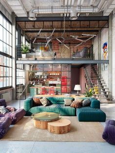 a living room filled with furniture and lots of windows