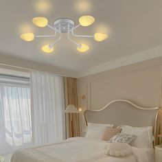 a white bed sitting in a bedroom next to two lamps on either side of the bed