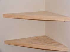 two wooden shelves against a white wall