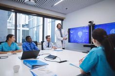 a group of people sitting around a conference table