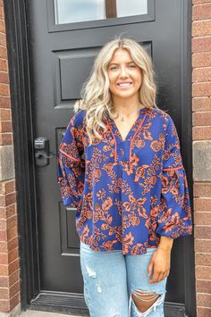 The Navy Printed Balloon Sleeve Top is a chic and versatile addition to your wardrobe, perfect for adding a touch of elegance to both casual and dressy outfits. Made from 100% polyester, this top offers a lightweight and comfortable fit that drapes beautifully on the body. The fabric is durable and easy to care for, making it a practical choice for everyday wear. This top features a striking print against a deep navy background, adding visual interest and a sophisticated touch. The balloon sleev Flowy V-neck Top For Work, Chic Floral Print Top With Split Neck, Flowy Viscose Blouse For Day Out, Chic Split Neck Top For Day Out, Chic Flowy Blouse With Split Neck, Casual Viscose Tops For Brunch, Chic Split Neck Top For Vacation, Chic Split Neck Blouse For Vacation, Flowy V-neck Top For Workwear