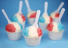 red, white and blue cupcakes with spoons in them on a blue background