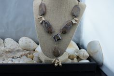 "This is the perfect option for those who like cool, unique jewelry and the luxury, shine of silver, brown. This necklace is well made, cute and/or elegant in design, and very desirable. Its style is a Sautoir, with its beautiful Petrified Wood stones and 4 dangles of genuine champagne pearls hanging 2-1/2 inches from a square bronze glass bead. See all our pictures. Going up each side of the main necklace are brownstones with lots of matrices. They are expertly matched on each side, on sterling Unique Sterling Silver Jewelry With Polished Beads, Handmade Earthy Silver Jewelry, Earthy Handmade Silver Jewelry, Silver Beaded Dangle Necklaces As Gift, Dangle Silver Beaded Necklaces As Gift, Silver Beaded Dangle Necklaces For Gifts, Brown Jewelry With Unique Variations And Round Beads, Silver Bead Dangle Necklaces For Gifts, Dangle Silver Beads Necklace For Gift