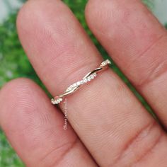 a close up of a person's hand with a ring on their finger,