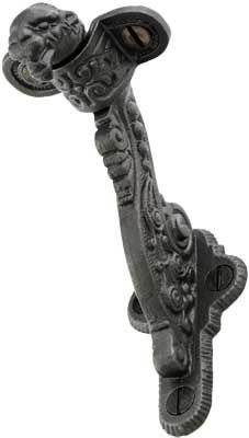 an ornate iron door handle on a white background