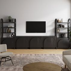 a living room with two couches and a tv on the wall above it is an entertainment center