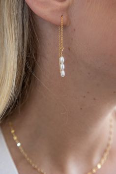 These pearl threaders are a dainty statement earring - effortlessly draping to accentuate the beauty in every wearer. We love a threader for an understated elegance incorporated into your weekly routine. 4" total length Genuine Freshwater Pearls Gold Filled Threaders Nickel Free Hypoallergenic Designed and handmade at Adorn's storefront in Steamboat Springs, CO Care: Avoid salt water, chlorine and harsh chemicals. Polish regularly with a jewelry cloth to improve shine. Be mindful that perfume, l Elegant Teardrop Threader Earrings For Everyday, Elegant Teardrop Threader Earrings, Elegant Everyday Teardrop Threader Earrings, Everyday Minimalist Pearl Chain Earrings, Minimalist Pearl Chain Linear Earrings, Everyday Pearl Drop Threader Earrings, Adjustable Elegant Linear Earrings For Everyday, Minimalist Pearl Linear Earrings, Elegant Everyday Adjustable Linear Earrings