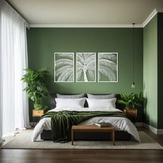 a bedroom with green walls, white bedding and two paintings hanging on the wall