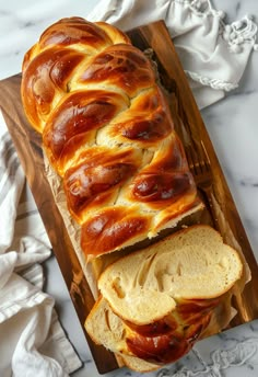 a loaf of hot dog bread sitting on top of a cutting board