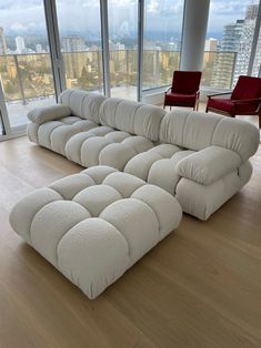 a large white couch sitting on top of a hard wood floor