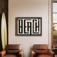 two brown leather chairs sitting in front of a wall with a surfboard on it