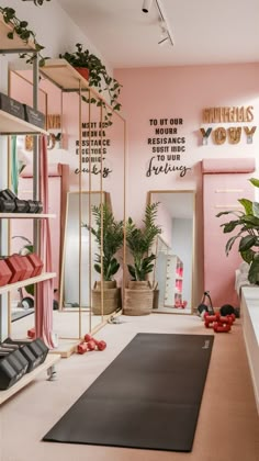 a room with pink walls and lots of plants