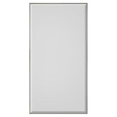 a white wall mounted mirror on the side of a wall with an empty glass door