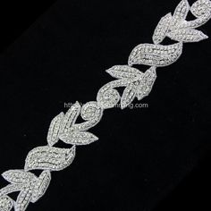 a white diamond bracelet on a black background with the words,'love is in the air