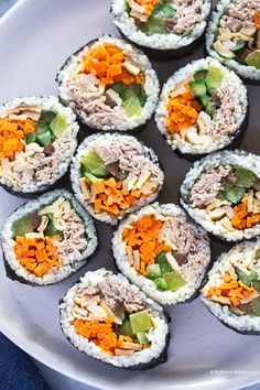 sushi rolls with vegetables and meat on them are arranged in a griddle pattern