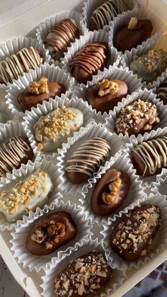 a box filled with lots of different types of chocolates on top of each other