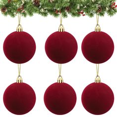 four red ornaments hanging from a christmas tree