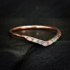 a gold ring with opal stones on it