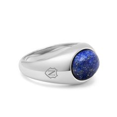 The Silver Oval Signet Ring with Blue Lapis by Nialaya is a luxurious fusion of elegance and sophistication. With its polished blue lapis gemstone set in sophisticated silver, it exudes timeless style and refinement. Whether worn for special occasions or as a daily accessory, this ring is sure to make a statement and become a cherished heirloom. Ring in Stainless Steel Blue Lapis Stone Elegant Blue Oval Cabochon Signet Ring, Timeless Sterling Silver Rings For Everyday Luxury, Luxury Tanzanite Jewelry With Polished Finish, Modern Sapphire Ring Oval Cabochon Polished Finish, Modern Sapphire Ring With Oval Cabochon And Polished Finish, Timeless Blue Gemstone Signet Ring, Elegant Blue Sapphire Signet Ring, Classic Blue Lapis Lazuli Rings, Timeless Blue Signet Ring With Polished Finish