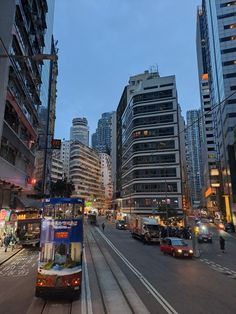 a city street filled with lots of traffic and tall buildings next to eachother