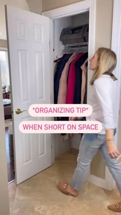 a woman is walking through an open closet