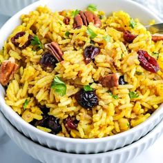 a white bowl filled with rice and cranberries