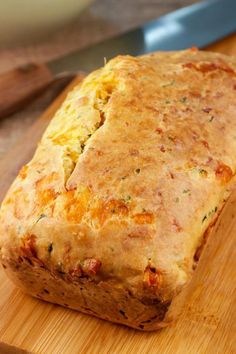 a loaf of bread sitting on top of a wooden cutting board