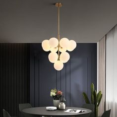 a dining room table with four chairs and a potted plant on top of it