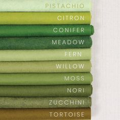 a stack of folded sheets sitting on top of each other in green and yellow colors